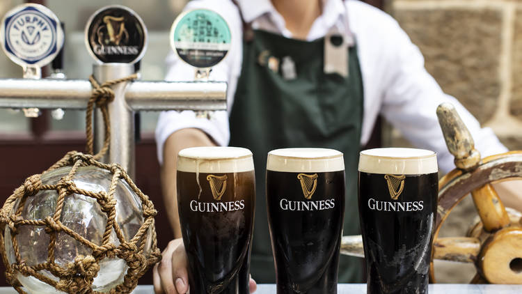 Three pints of Guinness on the bar at the Doss House