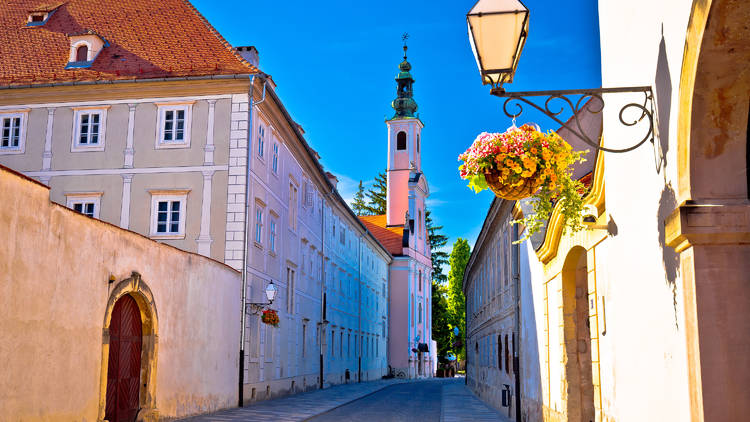 Lamp sconces graced with flowers among Baroque architecture in Varaždin city