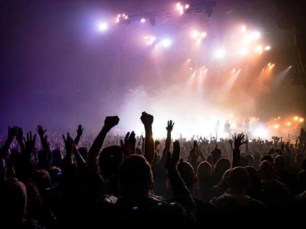 Crowd at a concert, with lights and smoke Crowd at a concert, with lights and smoke