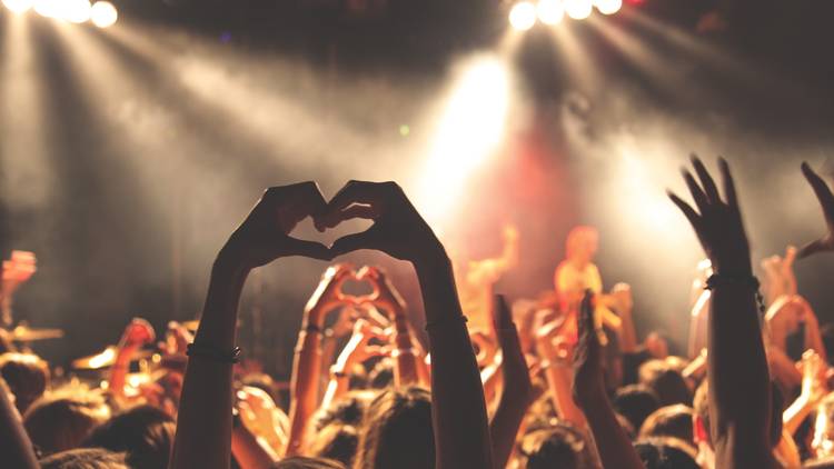 Hand making heart gesture at concert