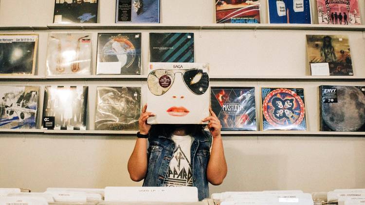 Woman holding vinyl record to her face