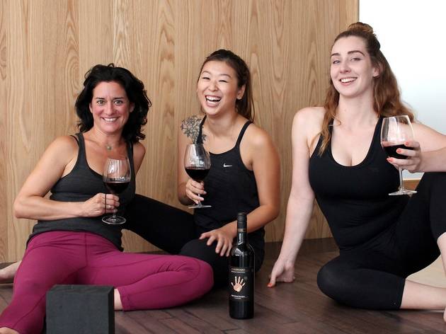 Virtual Yoga and Wine Three women in activewear sitting around drinking wine