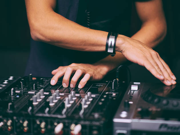 Vibe virtually with funky online gigs this weekend DJ's hands control the remote control close-up