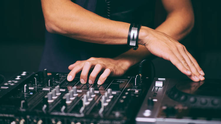 DJ's hands control the remote control close-up