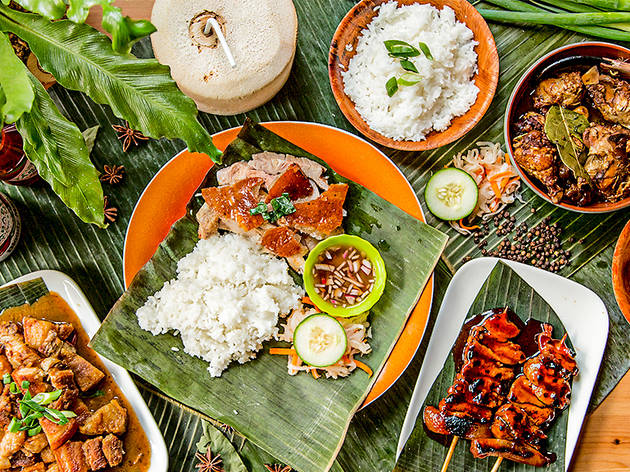 Sydney Cebu Lechon An overhead shot of roasted pork, skewers and rice laid out on banana leaves at Sydney Cebu Lechon