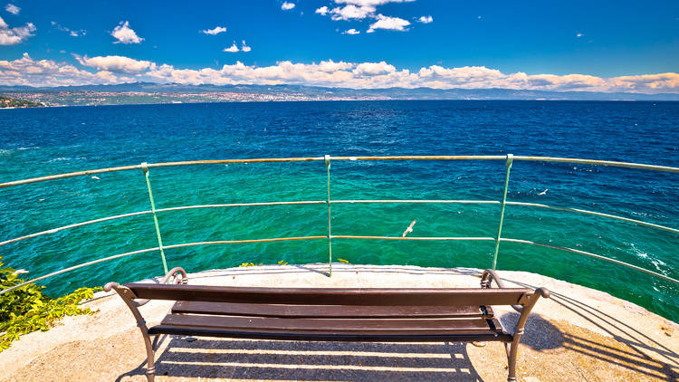 Bench by the sea on Lungomare walkway in Opatija riviera