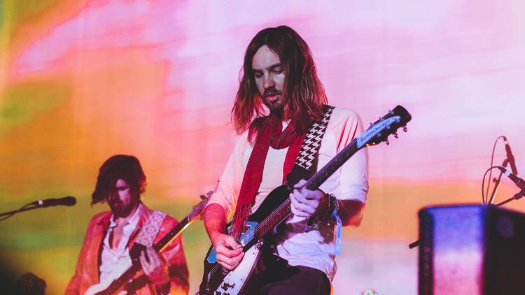 Frontman of Tame Impala with guitar