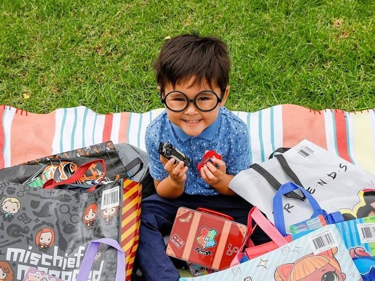 Child surrounded by showbags