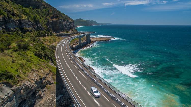 Car driving over bridge aerial view