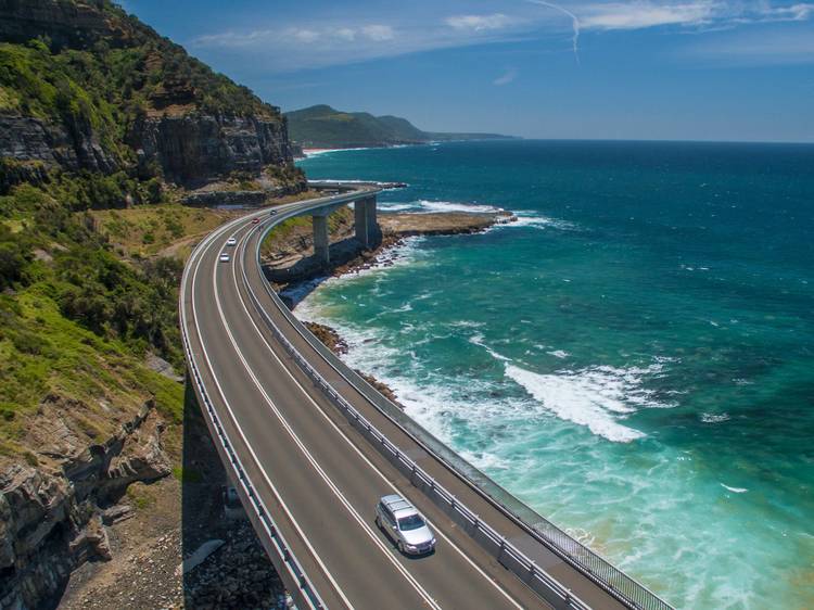 Car driving over bridge aerial view