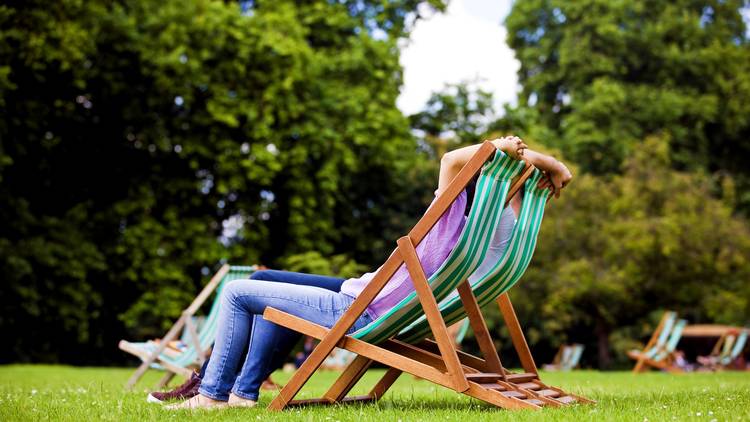 couple sitting on deck chairs in St James Park