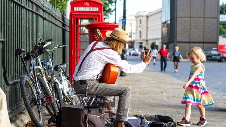 London busker and a little girl