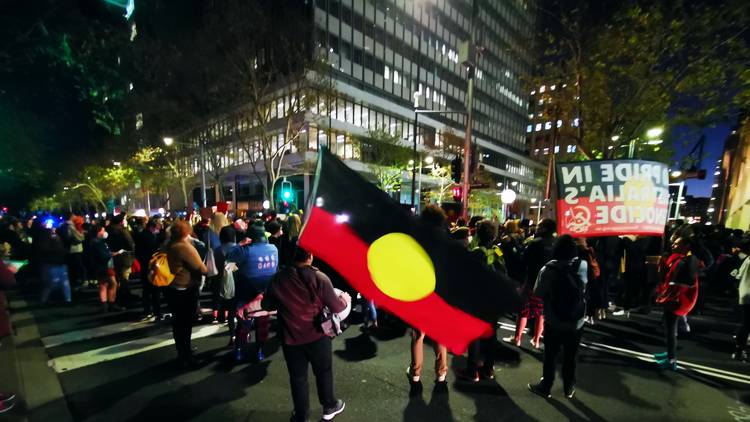Aboriginal flag and protestors