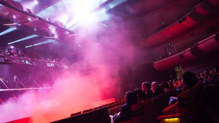 Ghostly Machines  - a crowd in hamer hall watching coloured smoke billow from the stage