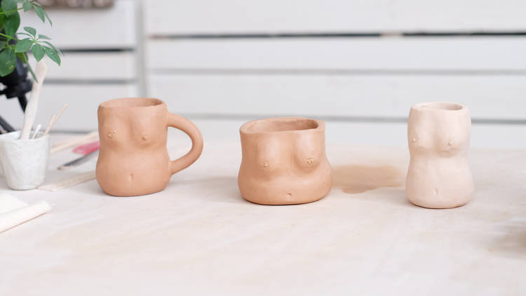 Three clay vessels depicting womanly forms