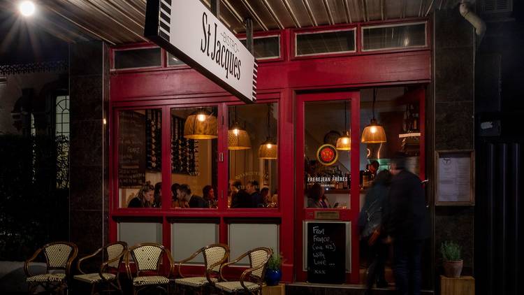 Man walking into red restaurant