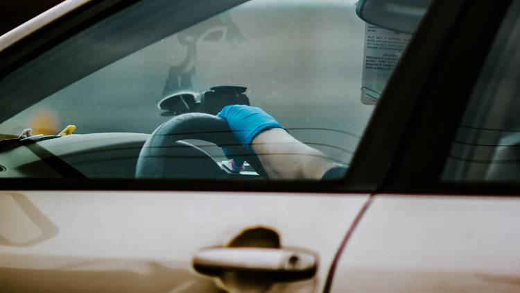 Driver wearing gloves at border crossing