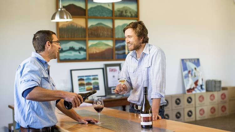 Two men talking over wine