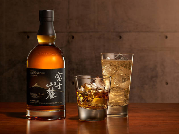 Fuji Sanroku Signature Blend whisky A bottle of Fuji Sanroku Signature Blend whisky on a table with two glasses