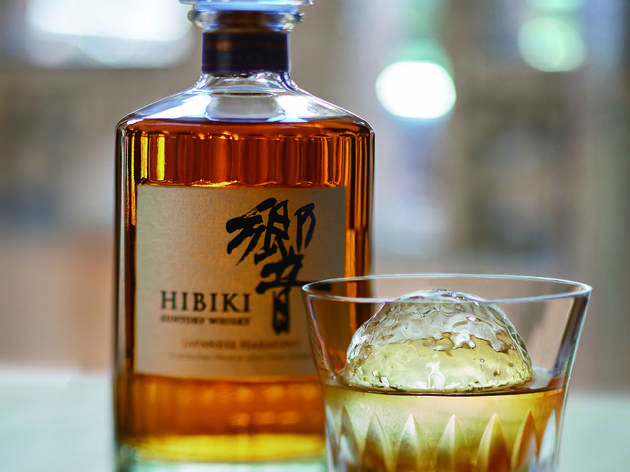 Suntory Hibiki Japanese Harmony whisky A bottle of Suntory Hibiki Japanese Harmony whisky on a table with a glass