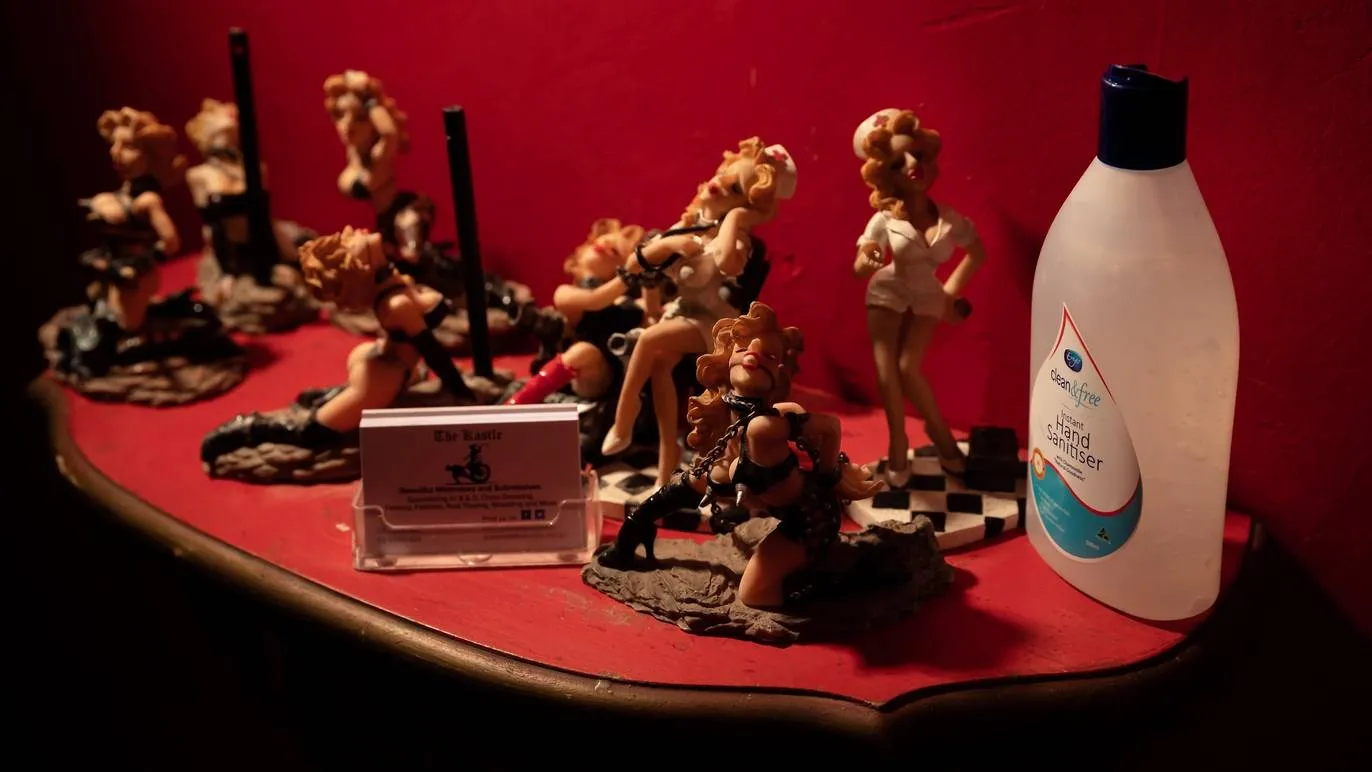 Statuettes and hand sanitizer in the dungeon's hallway.