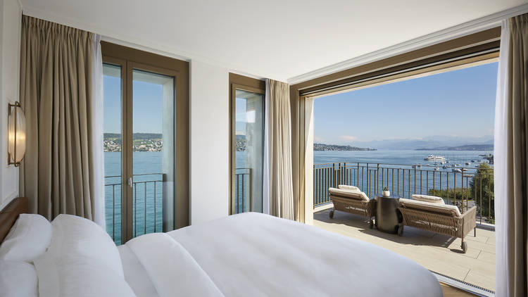 A hotel bedroom overlooking Lake Zurich.