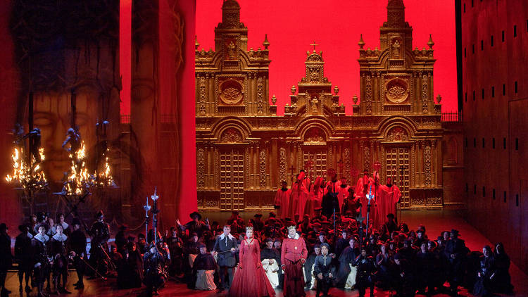 A scene from Act 2 of Verdi's "Don Carlo" with Simon Keenlyside as Rodrigo, Marina Poplavskaya (in red) as Elisabeth, Ferruccio Furlanetto (in red) as Philip II, and Roberto Alagna (kneeling) in the title role. Taken during the rehearsal on November 16, 2