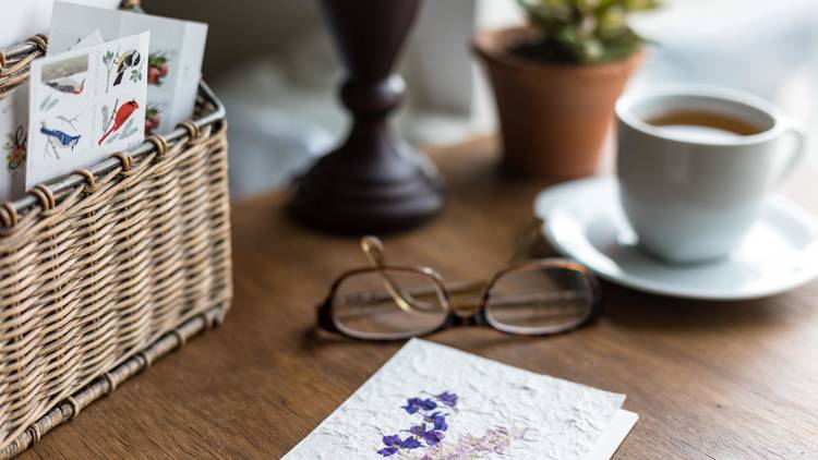 Letter on table next to glasses and mug