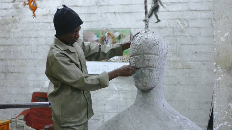 Person sculpting large figure