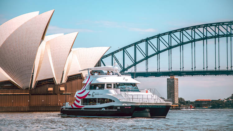 Journey Beyond Cruise vessel idles by the Opera House and Harbour Bridge