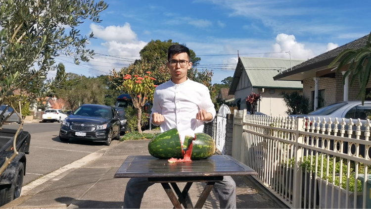 Person chopping watermelon in half for J-Talent quest
