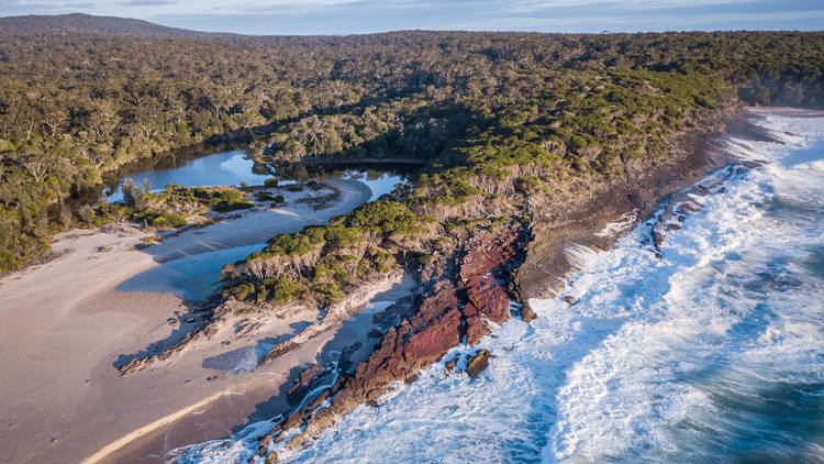 Dappled sunlight on river and river rocks Australian bush Stock