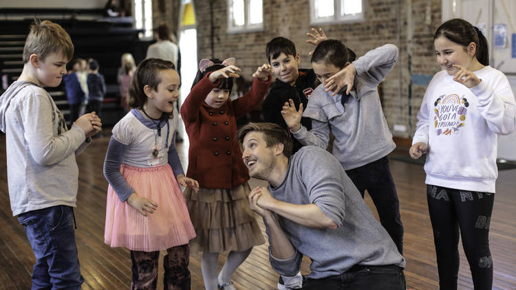 Kids and tutor having fun at ATYP school holiday drama workshops