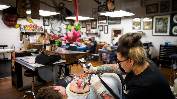Artists at work at Lighthouse Tattoo