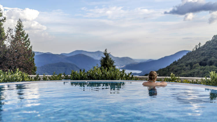 A hotel pool overlooking mountains.