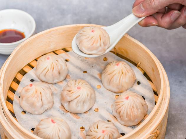 Dumplings Person picking up dumpling from steamer