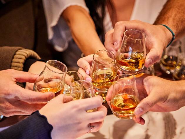 Whisky on the Rocks People clinking whisky glasses
