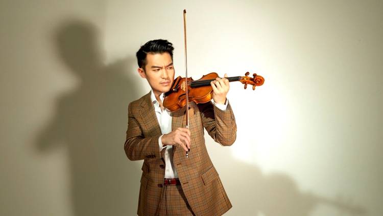 Ace violinist Ray Chen, wearing a natty tweed suit, prepares to play 