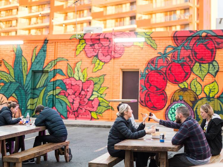 People sitting on benches drinking