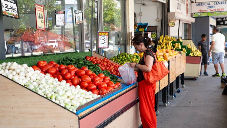 Woman shopping for fruit at Macquarie Fruit Shop