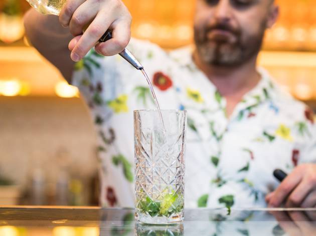 Man pouring spirit into mojito glass in liverpool Man pouring spirit into mojito glass