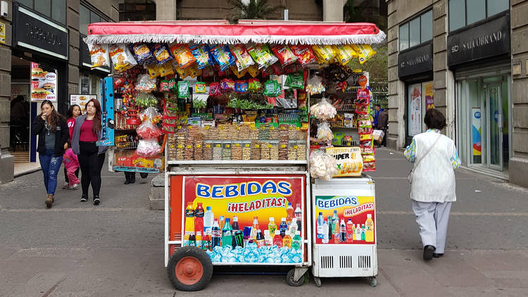 A snack cart laden with chips and cold drinks