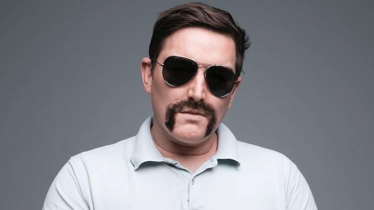 Comedian Heath Franklin as his stage persona 'Chopper' with aviator sunglasses and handlebar moustache.
