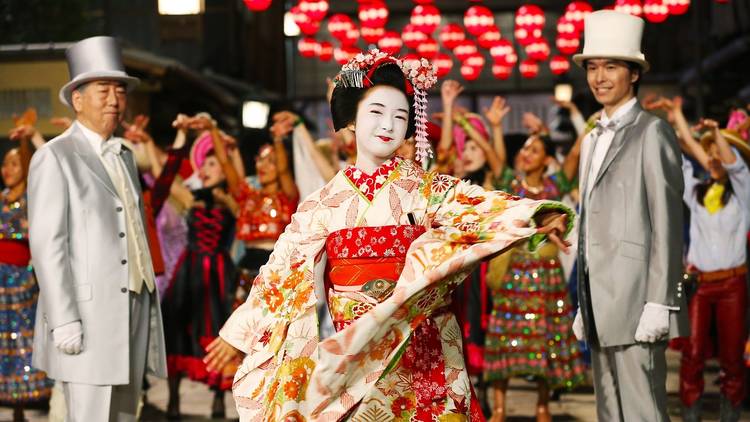 A geisha and two men in top hats