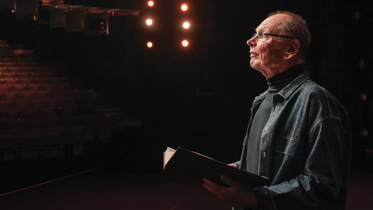 Bell Shakespeare founder John Bell on the Opera House stage, book in hand