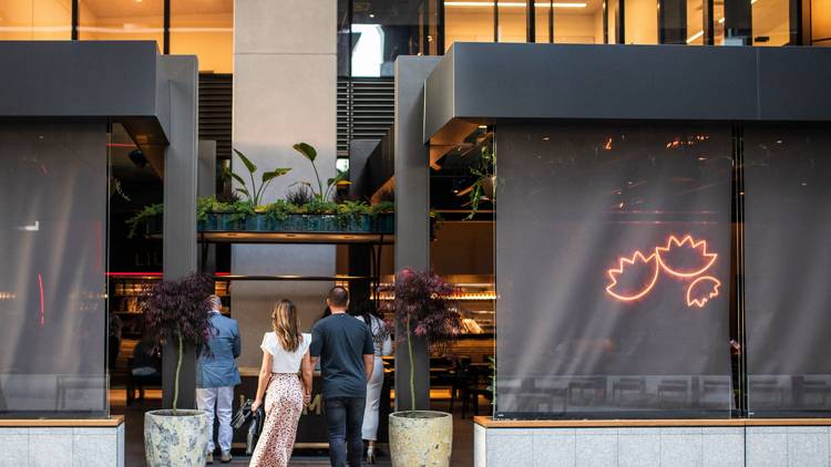 Two people walking into restaurant