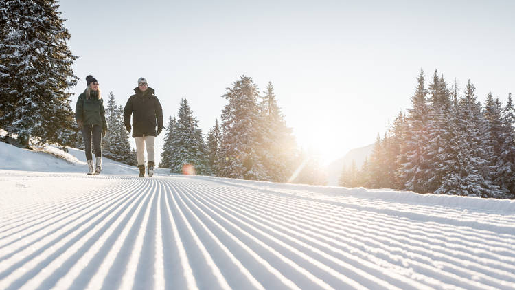 A romantic hike on a snowy hill in Gstaad.