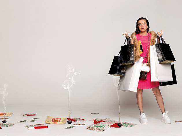 Golden Blood, Griffin 2021 A girl ini a pink dress clutching shopping bags with incense smoking all around her