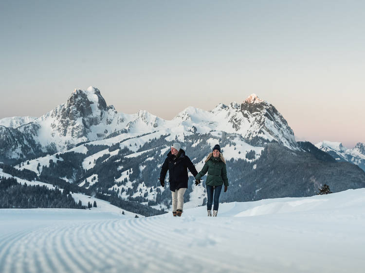 Hiking across a snowy mountain in Gstaad.