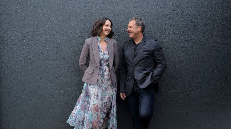 Couple leaning against a wall